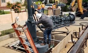 Line stop technician performing work on a pipeline with equipment in the background