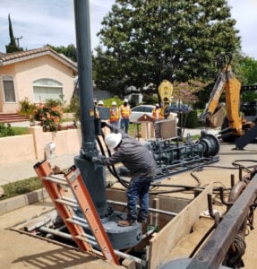 Line Stop technician standing on a matching as his completes a job near a neighborhood in California