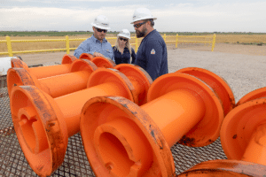 3 team members inspect the pipeline pigs after they've completed a run through a pipe section. 